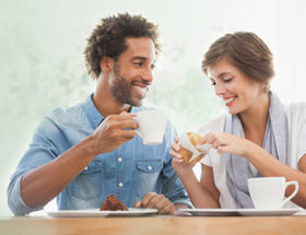 man and woman drinking coffee on a date