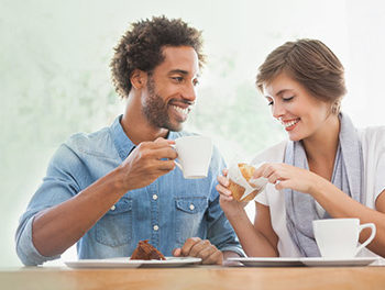 man and woman drinking coffee on a date
