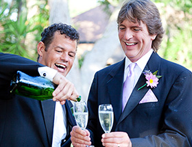 Gay couple drinking champagne