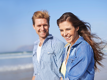 Couple with beach in the background